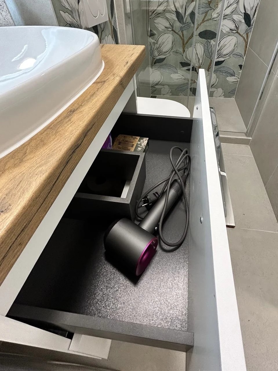 The hairdryer in the drawer under the washbasin