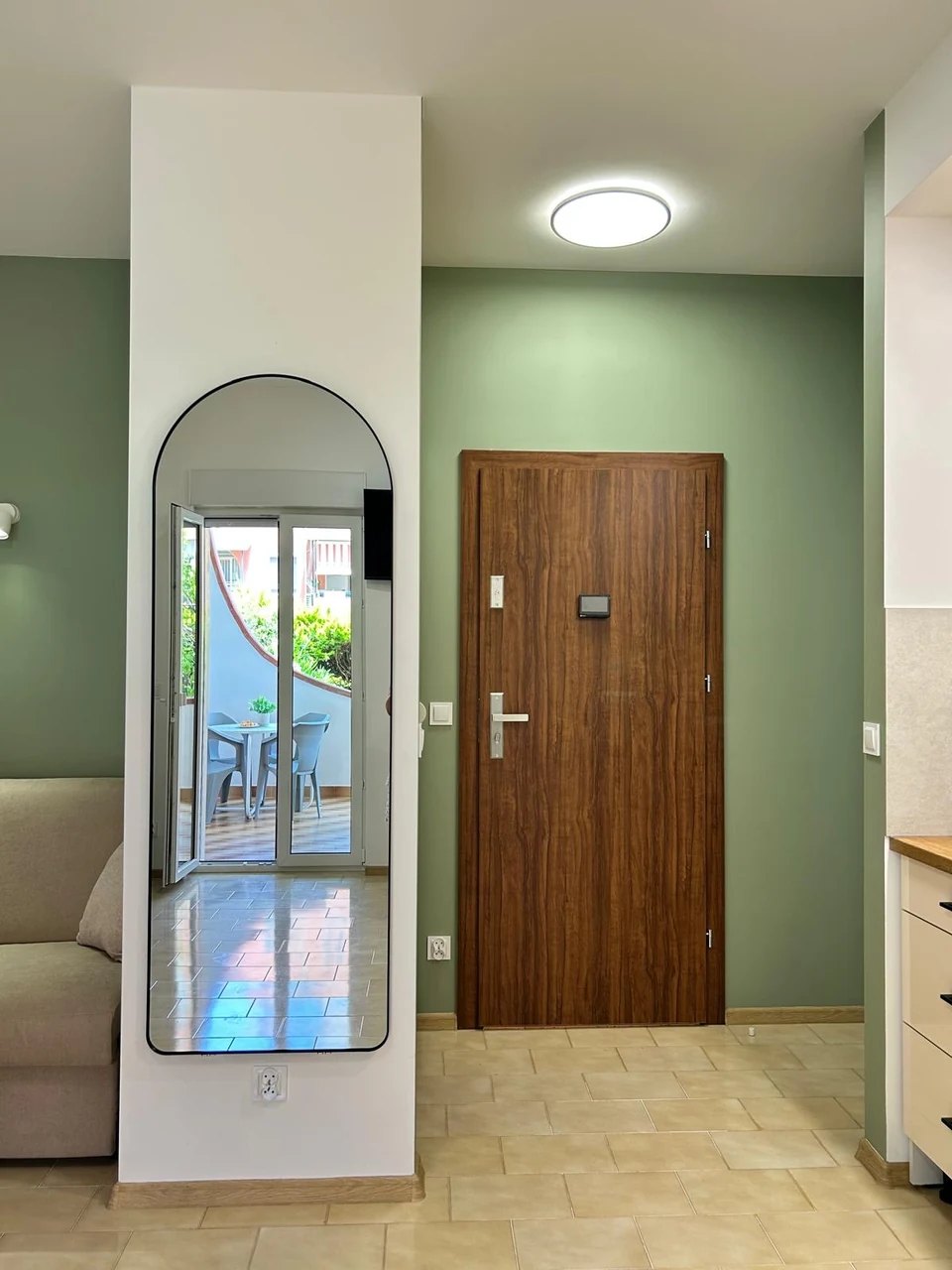 The full-length mirror by the entrance
